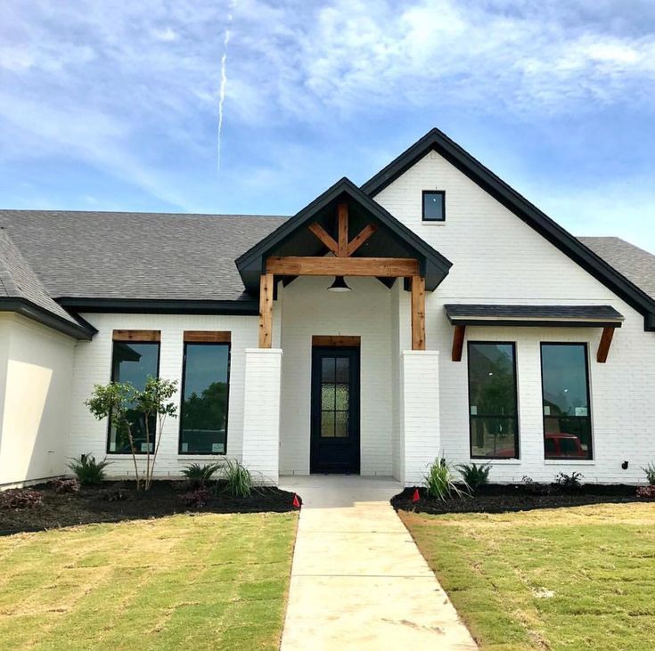 Wood Accent on White Home Exterior with Black Trim