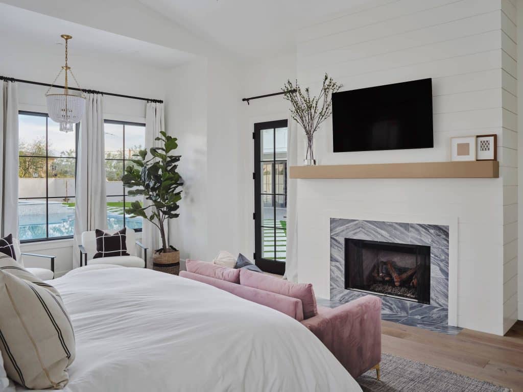 Farmhouse Bedroom with White Fireplace