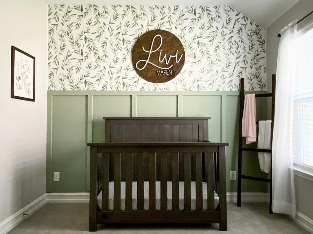 Green Half-Wall Wood Paneling with Herbal Wallpaper for a Nursery