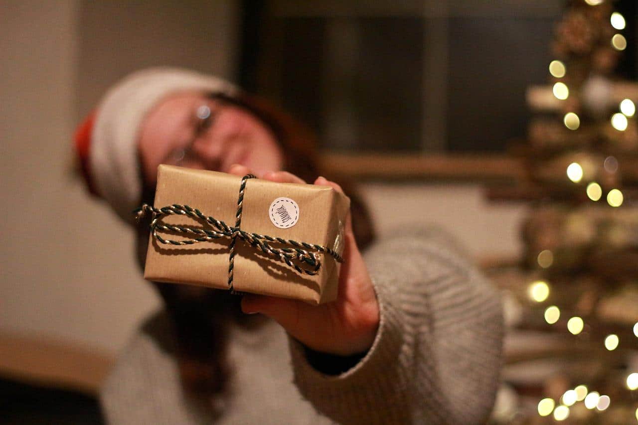 woman holding neatly wrapped gift