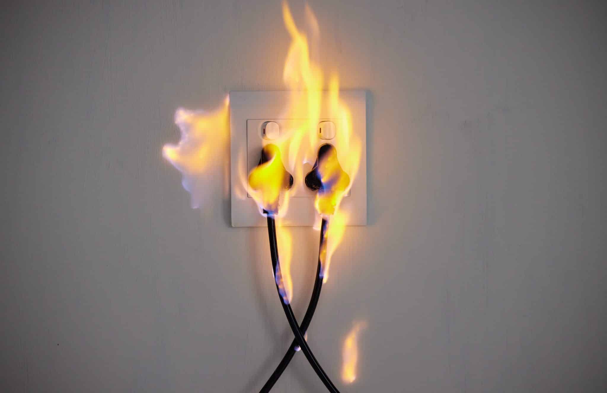 Electricity, fire and socket on wall of home with space for accident, connection or emergency. Cable, flame or insurance and plug in apartment for danger, power or safety with electrical current.