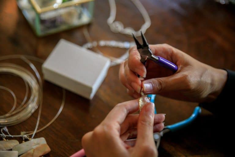 Free Detailed view showcasing the art of jewelry making with pliers and delicate hands. Stock Photo