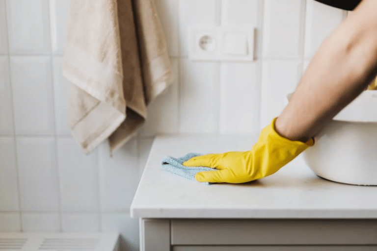 Professional cleaner tackling overlooked areas to meet inspection standards during house cleaning