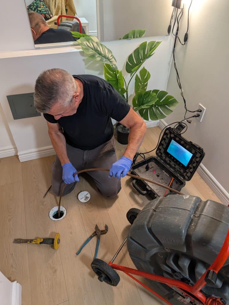 A man uses a tool to work on a tire