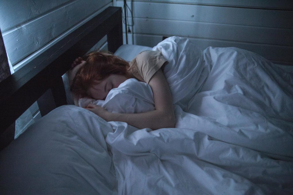 A woman sleeping in her bed