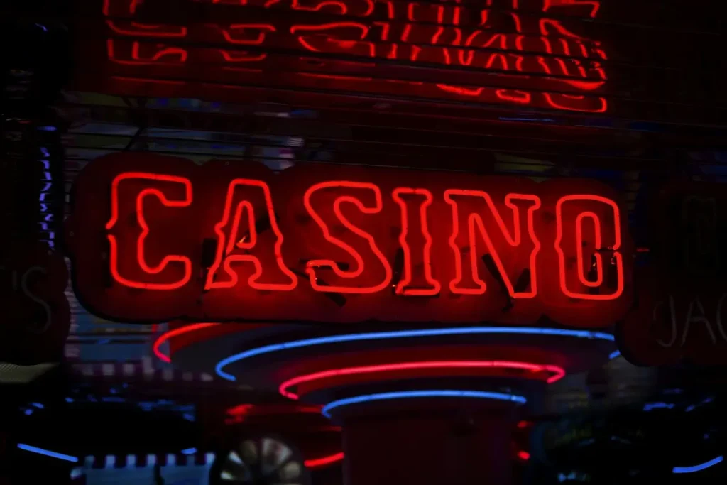 Red neon "CASINO" sign glowing brightly against dark background
