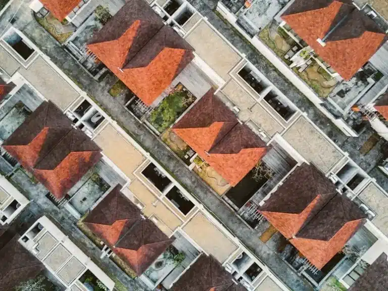 Aerial view of houses with red roofs arranged in a neat geometric pattern