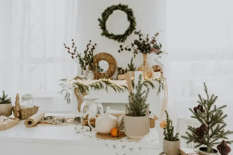 Festive indoor decor with wreaths, pine branches, and holiday items on a bright kitchen counter