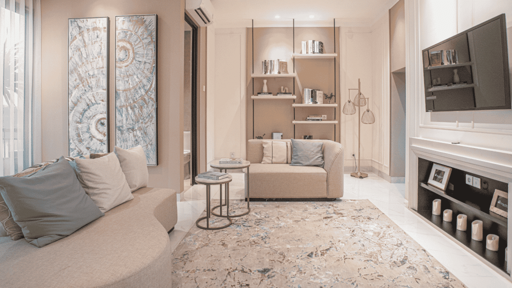 A bright, minimalist living room with a neutral sofa, tidy wooden coffee table, and large window. Clutter-free decor
