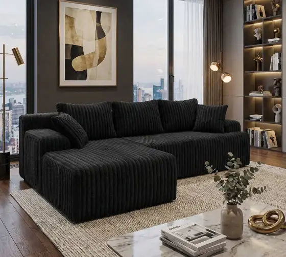 Dark gray sectional sofa in modern living room with abstract art and large windows