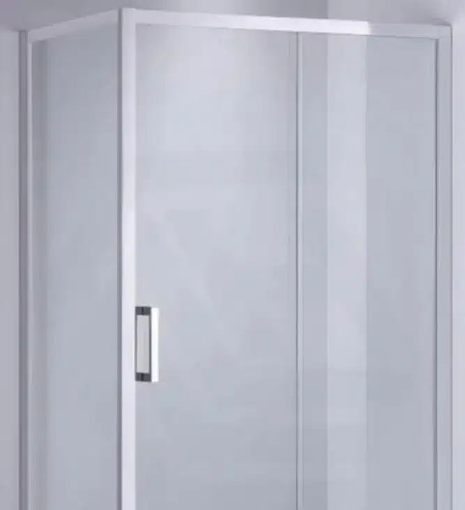 Glass shower enclosure with chrome handle in minimalist bathroom setting