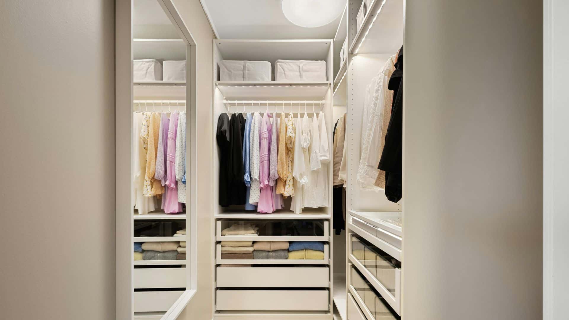 How to organize a small closet with shelves, drawers, and hanging space, showing neatly folded clothes, color-sorted outfits, and smart storage use