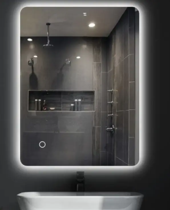 Modern bathroom with illuminated mirror, dark tiles, and chrome fixtures