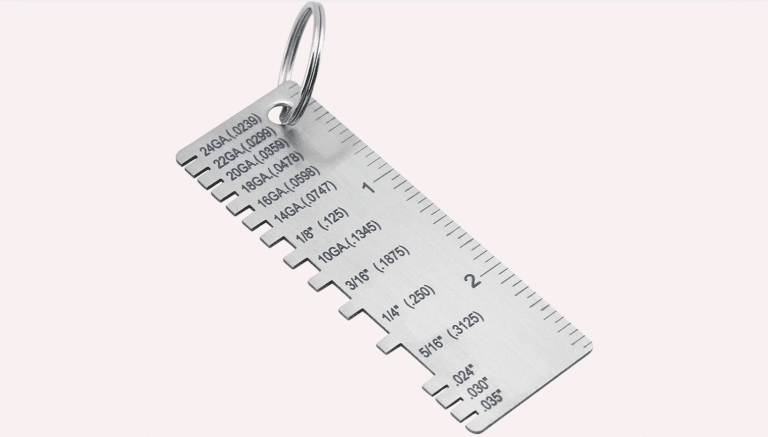 A metal wire thickness gauge tool showing etched measurements for various sheet metal gauges.