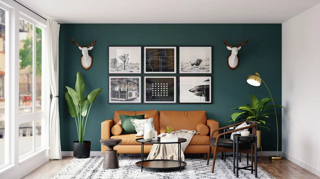 Warm living room with tan sofa, teal accent wall, indoor plants, and gallery-style framed art