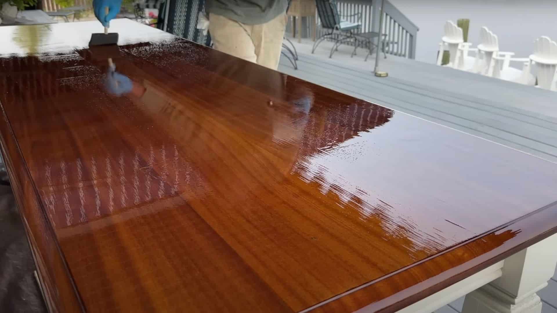 Applying the final layer of satin spar varnish to a wood project for a smooth, protective finish.