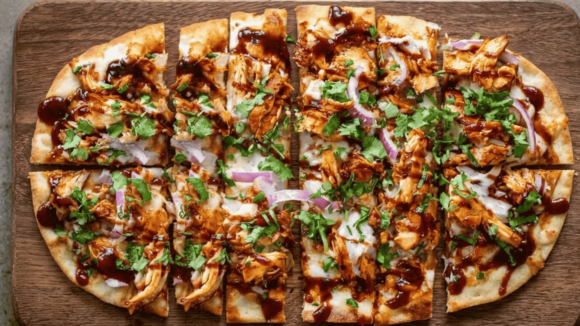 BBQ chicken flatbreads topped with melted cheese, red onions, cilantro, and smoky barbecue sauce on a crispy crust.