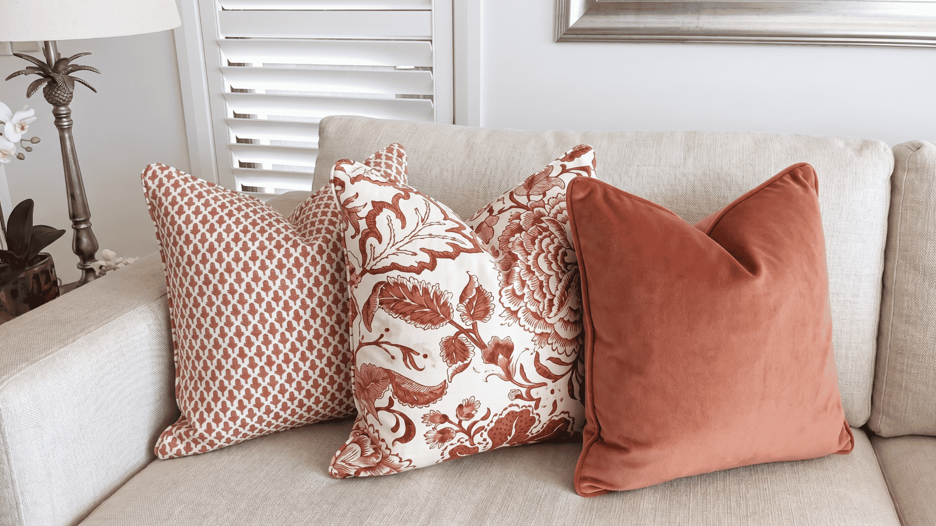 Alt text for the cushions image: **Close-up of a modular couch with four decorative cushions in patterned and solid fabrics, showing texture and depth.**