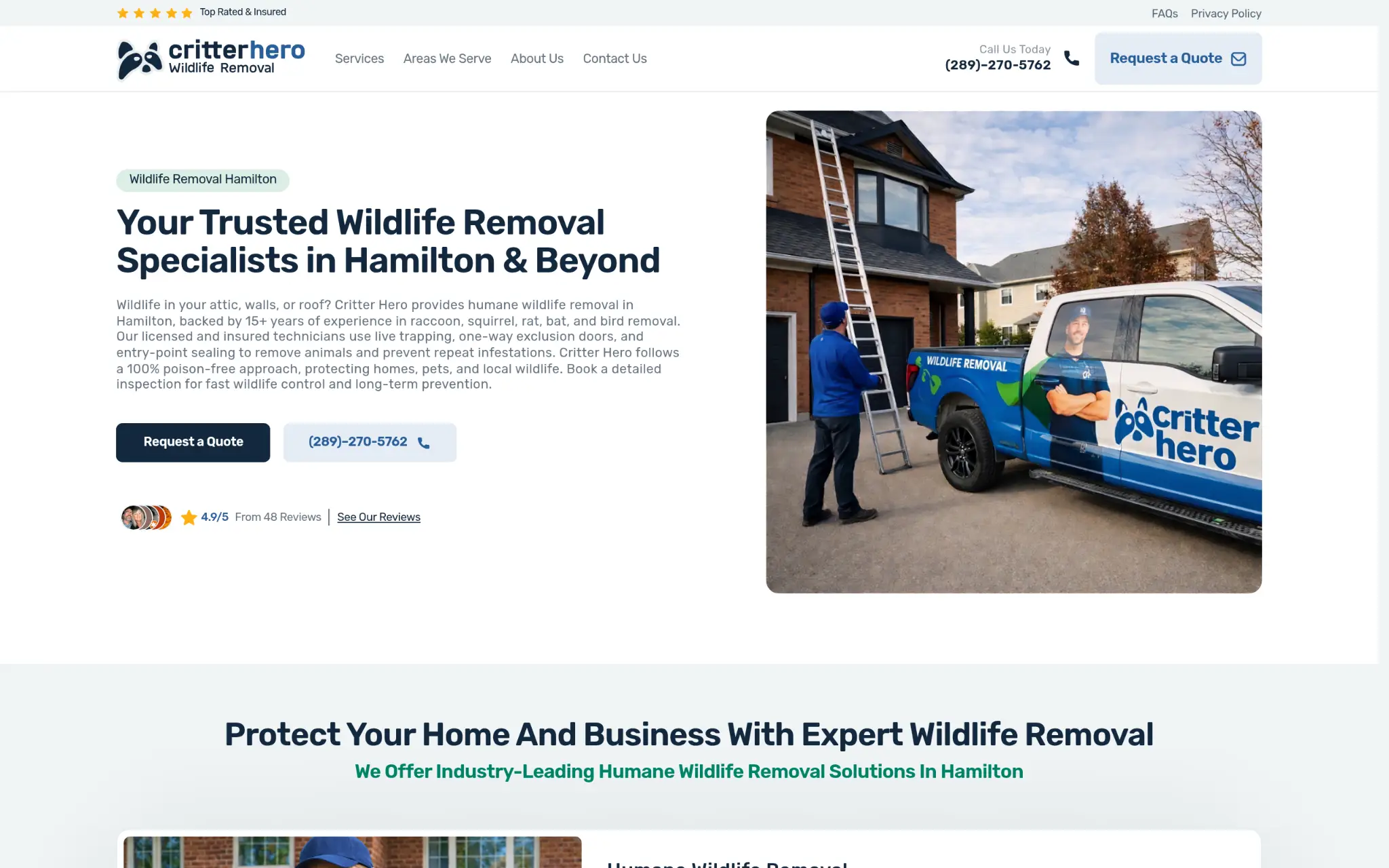 Worker in blue uniform standing by ladder next to wildlife removal truck in residential driveway
