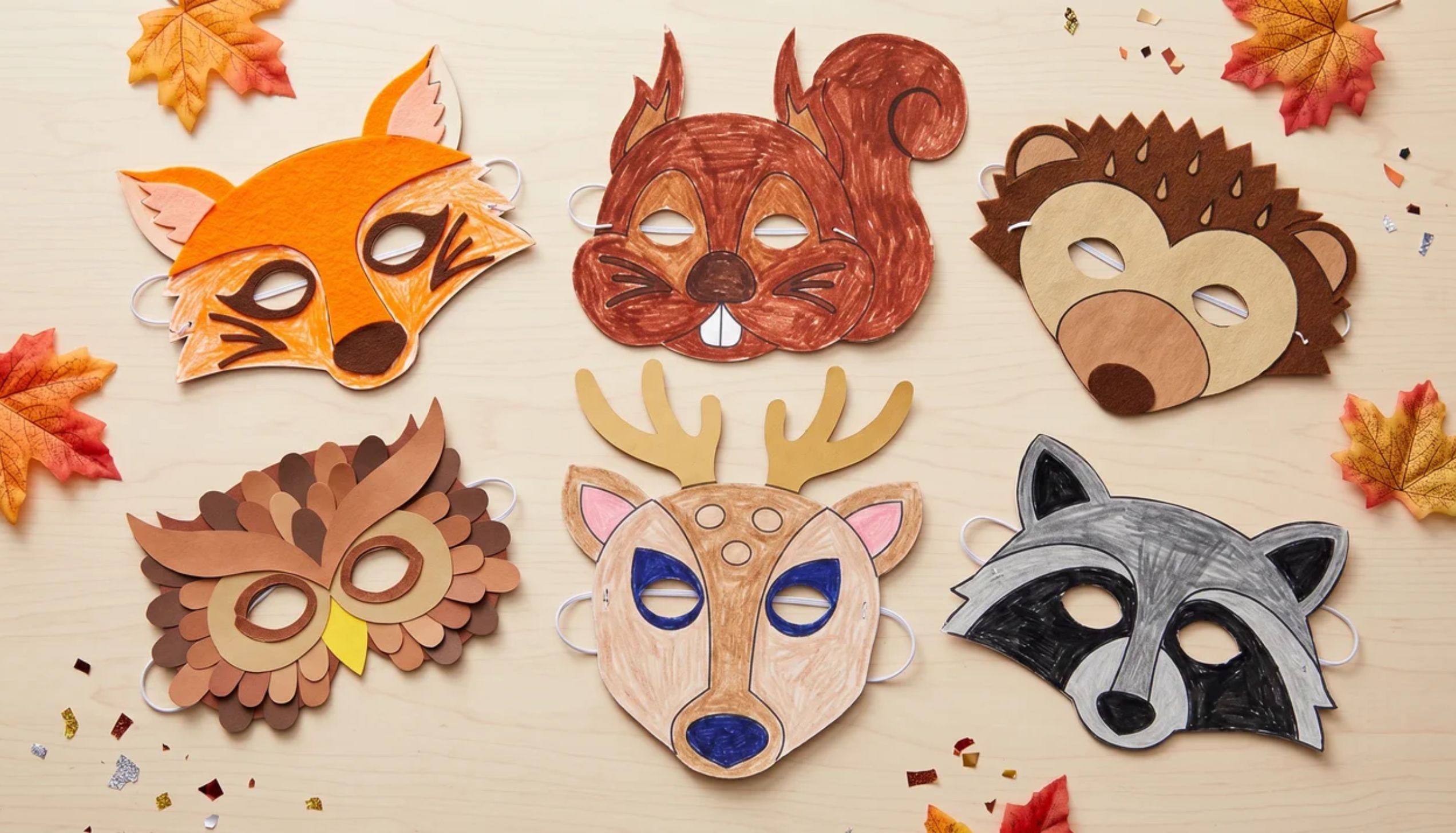 Six colorful woodland animal paper masks on a table, showcasing easy thanksgiving crafts.