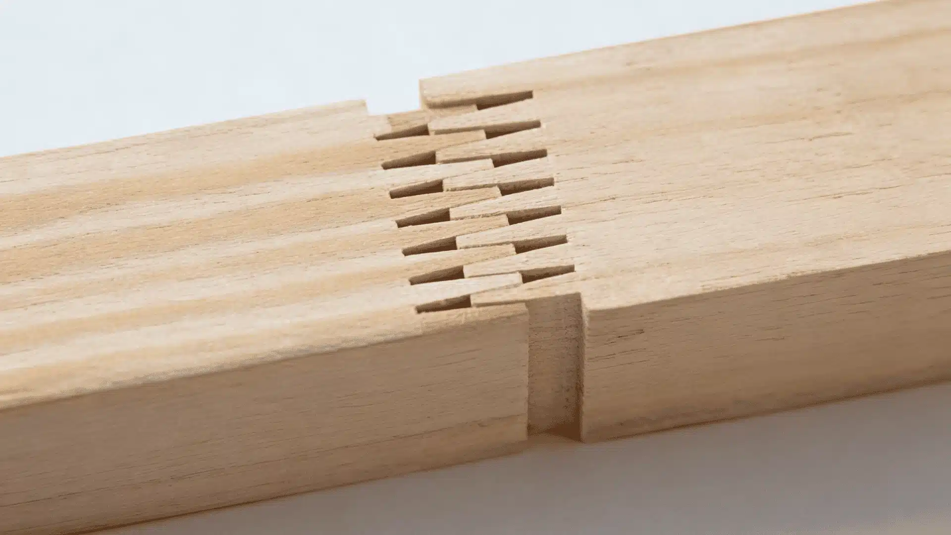 Finger joint connecting two wood pieces with interlocking cuts