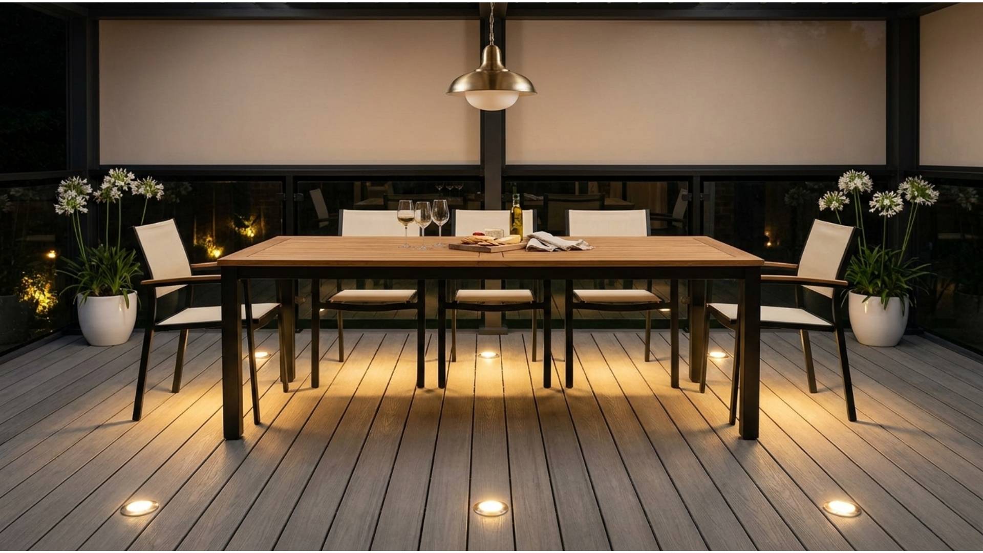 Outdoor deck dining set at night with low LED disc lights grazing the floor and base of chair and table legs