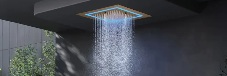 Ceiling-mounted showerhead with LED lighting, water cascading in a modern dark bathroom setting
