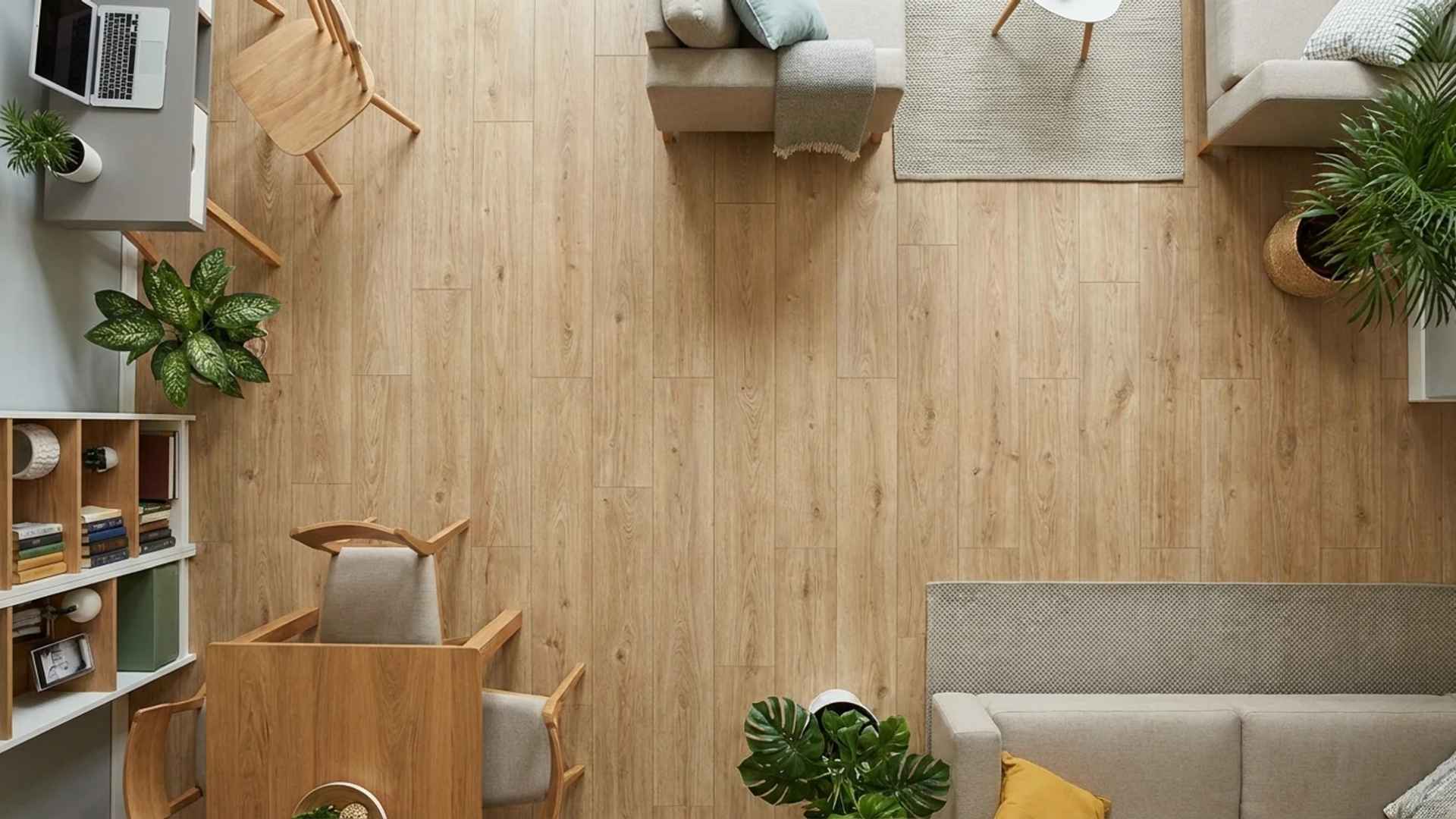 Close-up of durable, textured wood-look laminate planks showing realistic grain patterns on a living room floor.