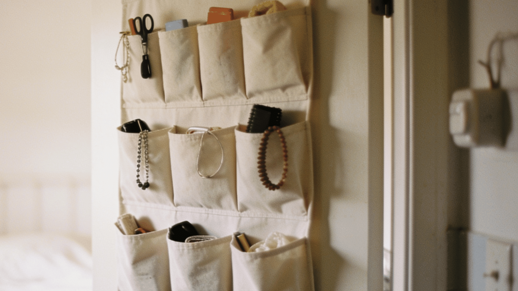 Over-the-door organizer with toiletries hanging on a door.