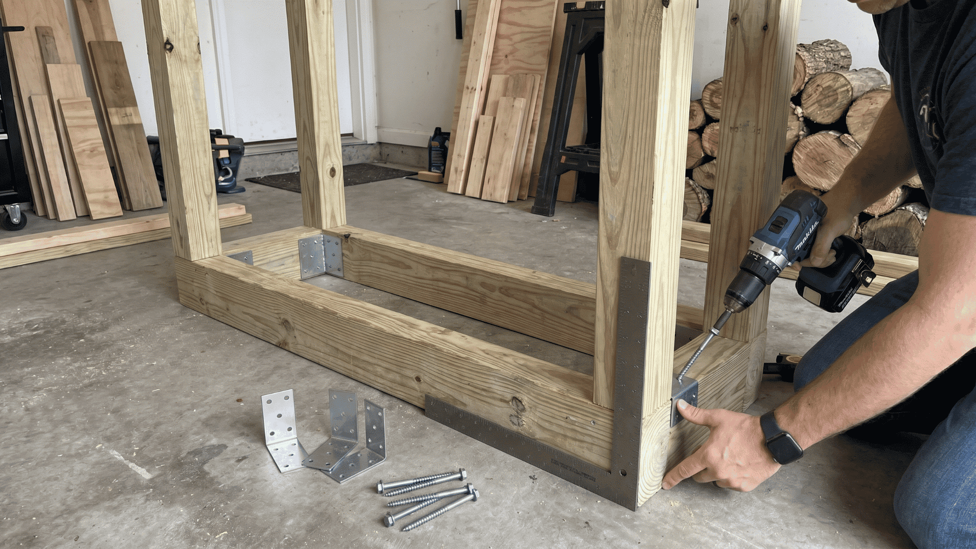 Person attaching upright beams to a wooden firewood rack base with screws and brackets