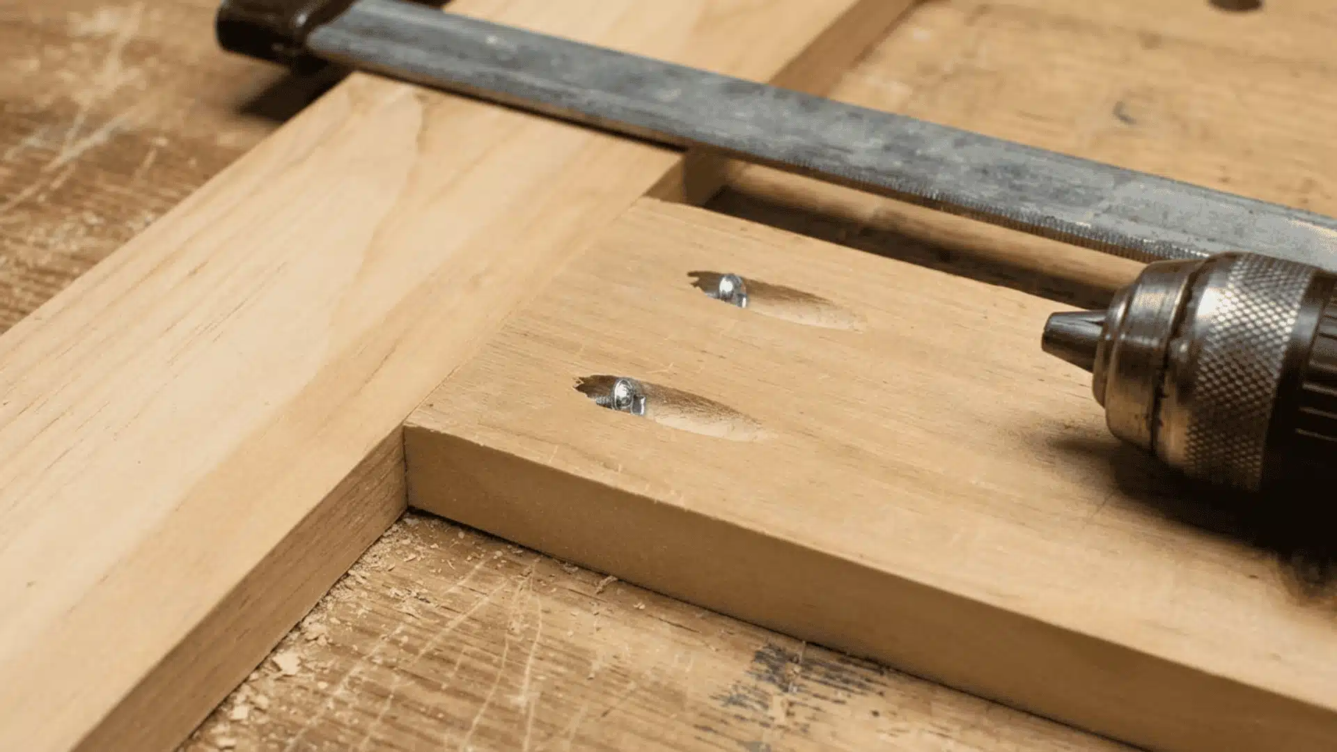 Pocket-hole screws connecting unfinished wood boards in a cabinet frame