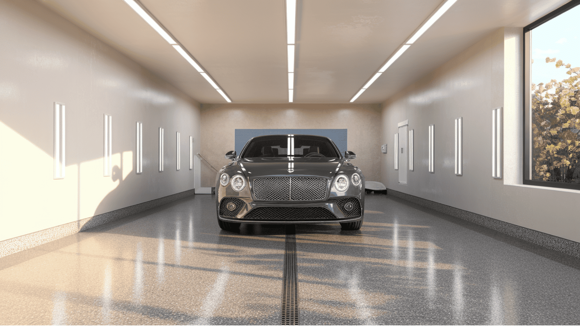 A dark-colored luxury sports car parked inside a bright showroom-style garage with a glossy, light grey polyaspartic floor.