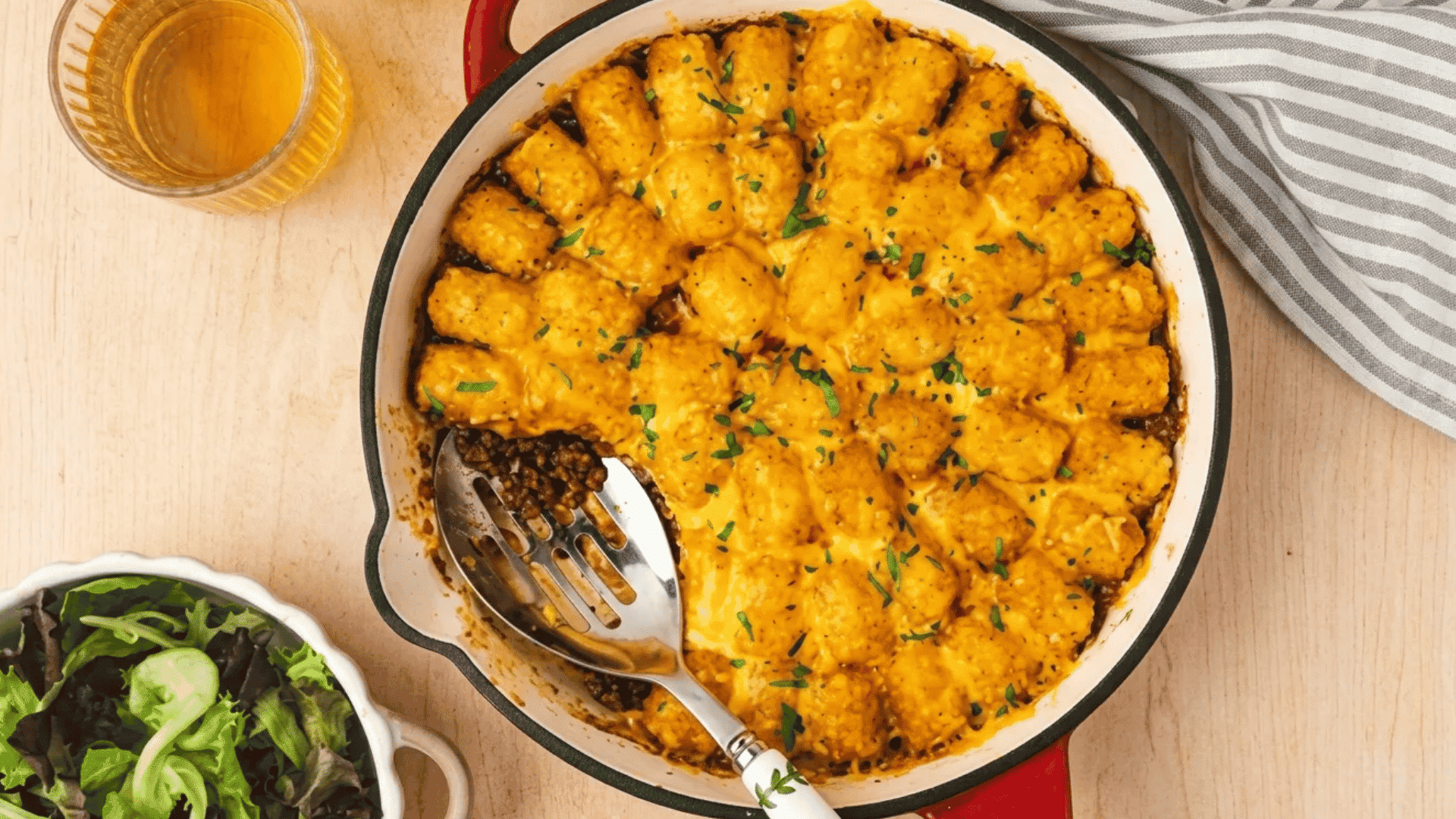 Cheesy tater tot casserole with crispy golden potatoes and rich beef filling underneath.
