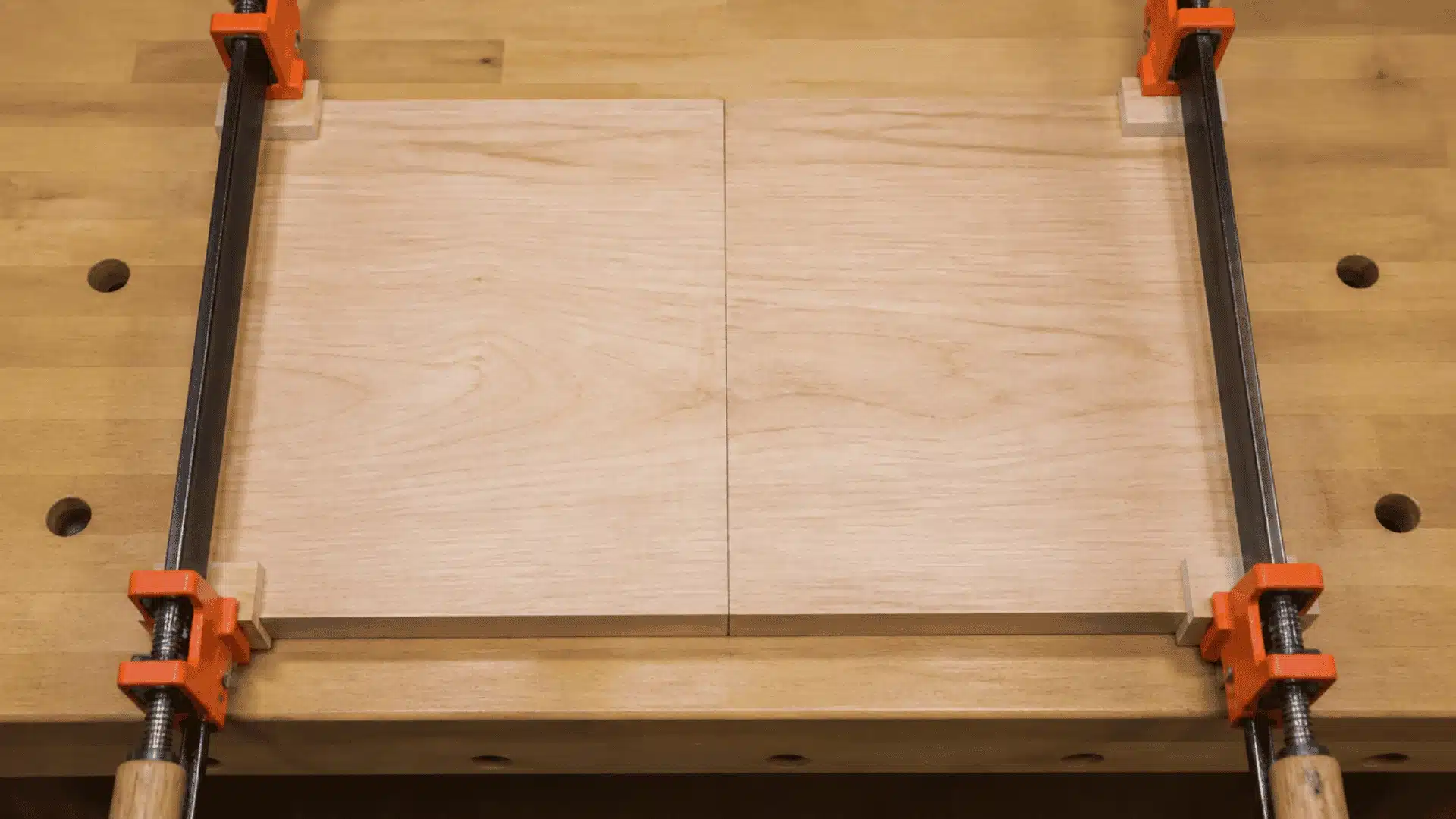 Two wood boards clamped together with an edge joint