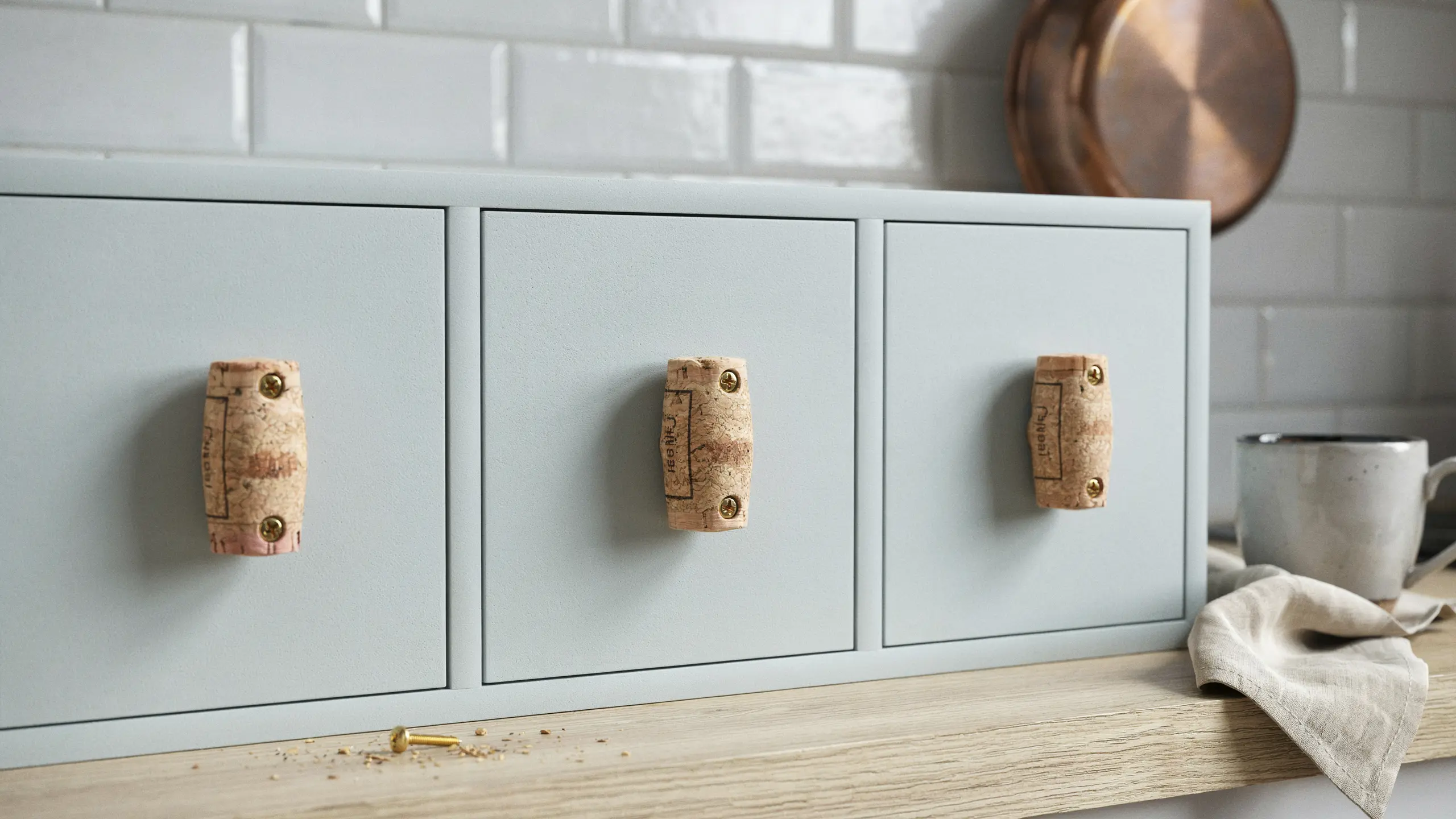 Kitchen cabinets with wine cork drawer pulls replacing knobs.