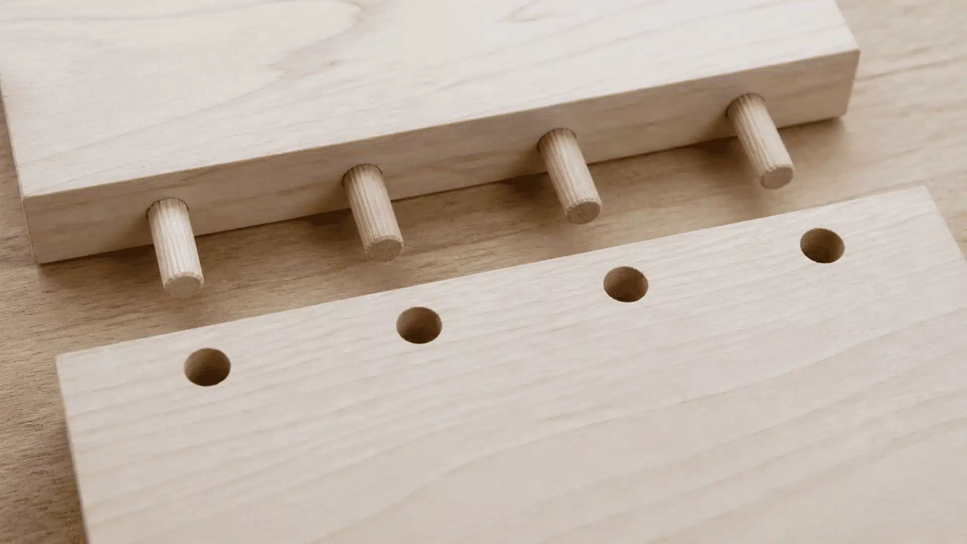 Wooden dowels inserted into drilled holes between two boards