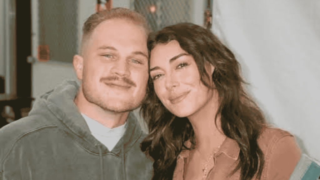 Zach Bryan and Samantha Leonard pose together after making their relationship public.