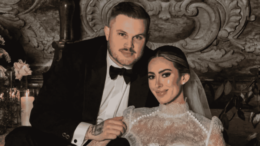 Zach Bryan and Samantha Leonard pose together in wedding attire after their marriage.