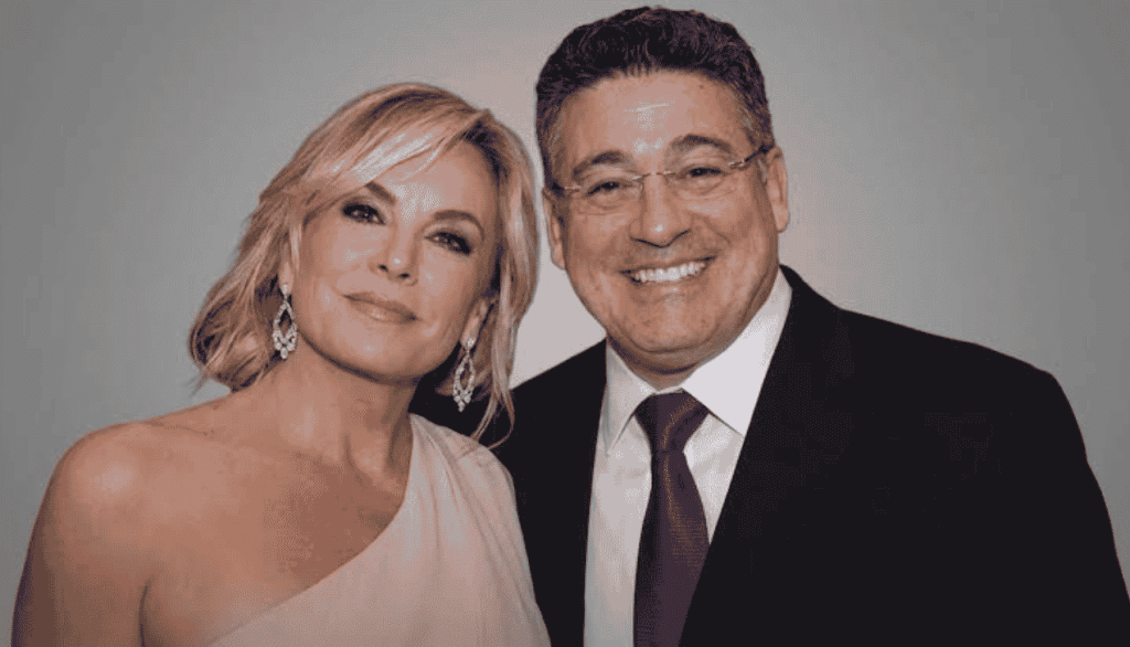 Itzhak Ezratti wife Anna Ezratti portrait with husband in studio-style shot, formal attire, neutral background lighting.