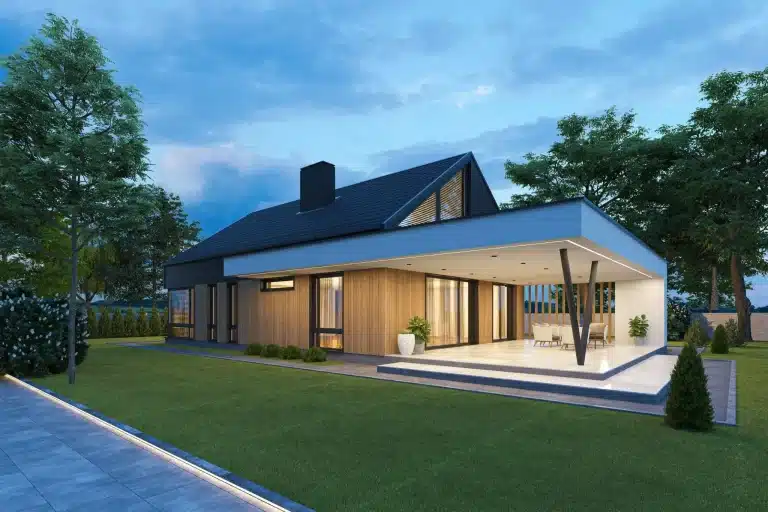 Modern house with wood paneling and large patio in landscaped garden at twilight