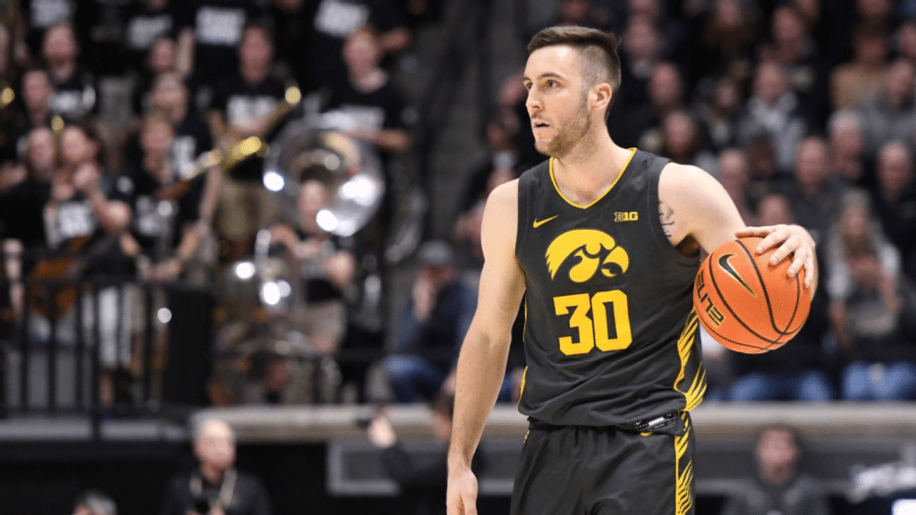 Connor McCaffery playing basketball for the Iowa Hawkeyes during a college game.