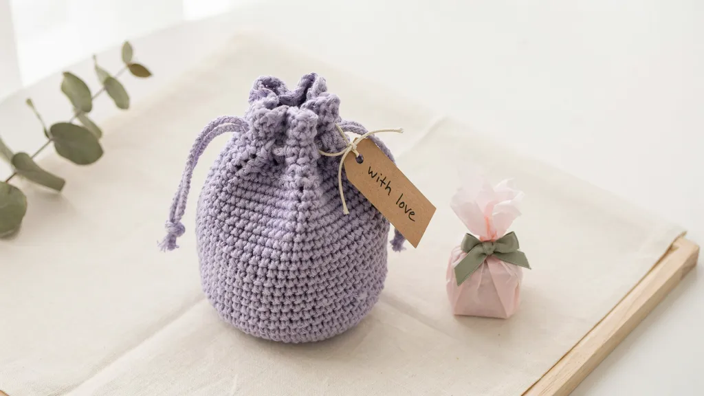 Simple crochet drawstring bag tied closed, styled as a quick handmade project.