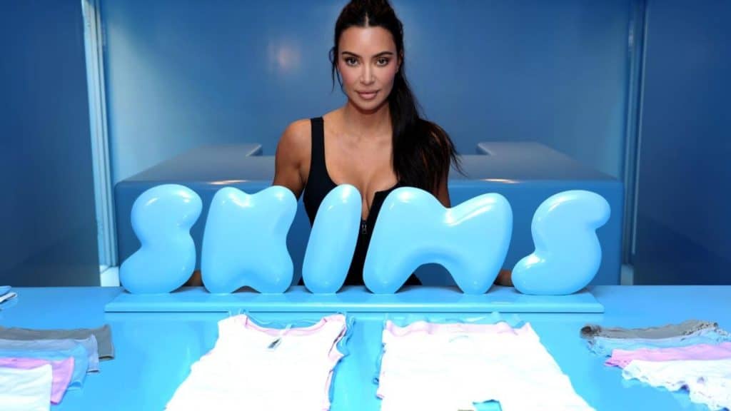 Kim Kardashian at a business event highlighting her brand and cultural influence.