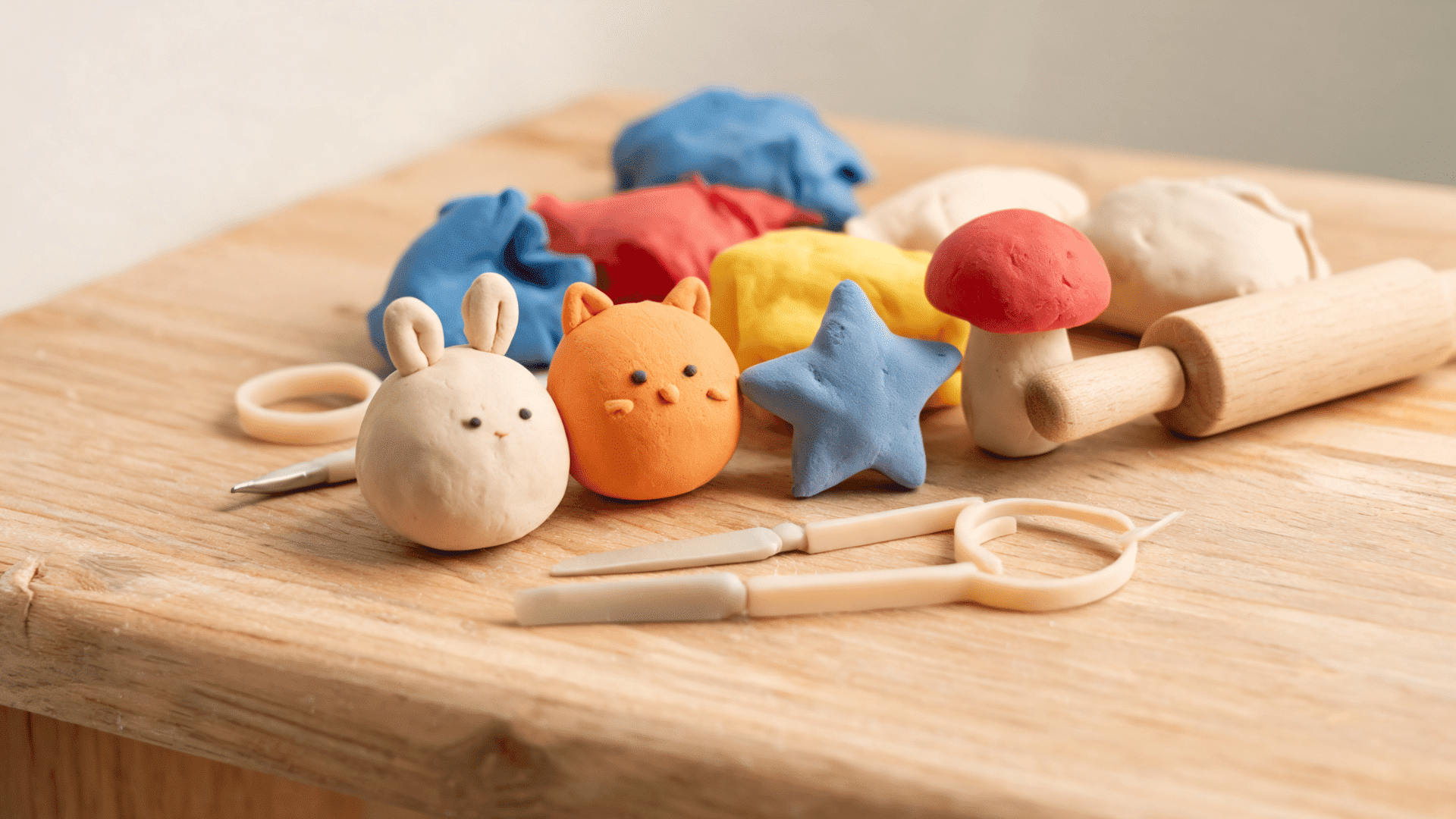Clay modelling art showing colorful clay figures with sculpting tools
