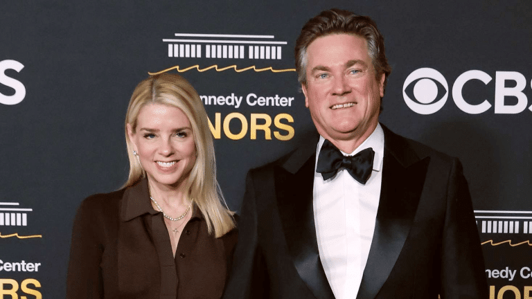 Pam Bondi and John Wakefield attending the Kennedy Center Honors event in formal attire on the red carpet.