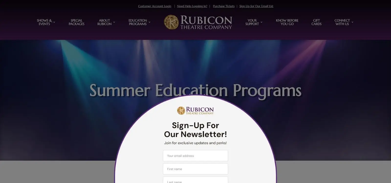 Stage lights in purple and blue over theatre website with newsletter sign-up form