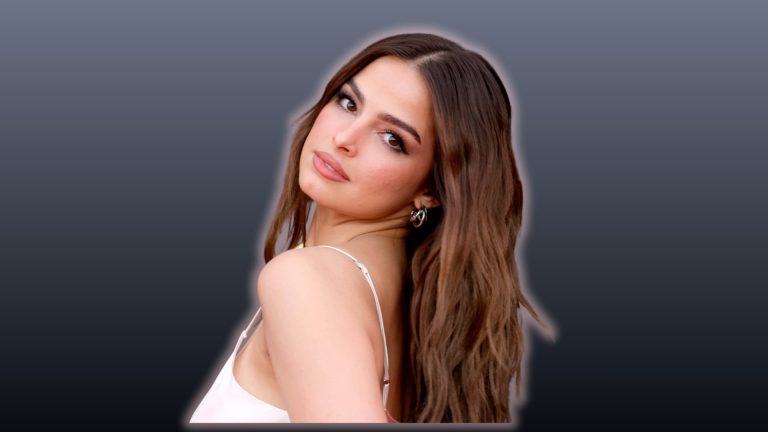 Addison Rae posing with long brown hair against a dark background