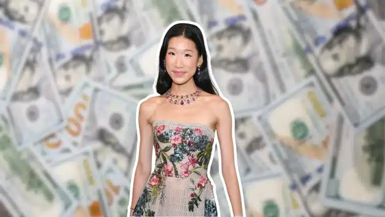 Becca Bloom wearing a floral dress and a jeweled necklace against a background of US dollar bills.
