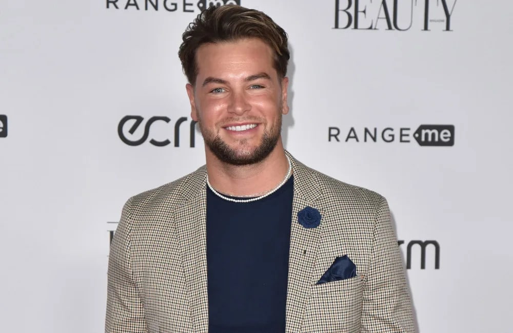 chris hughes standing infront of paparazzi