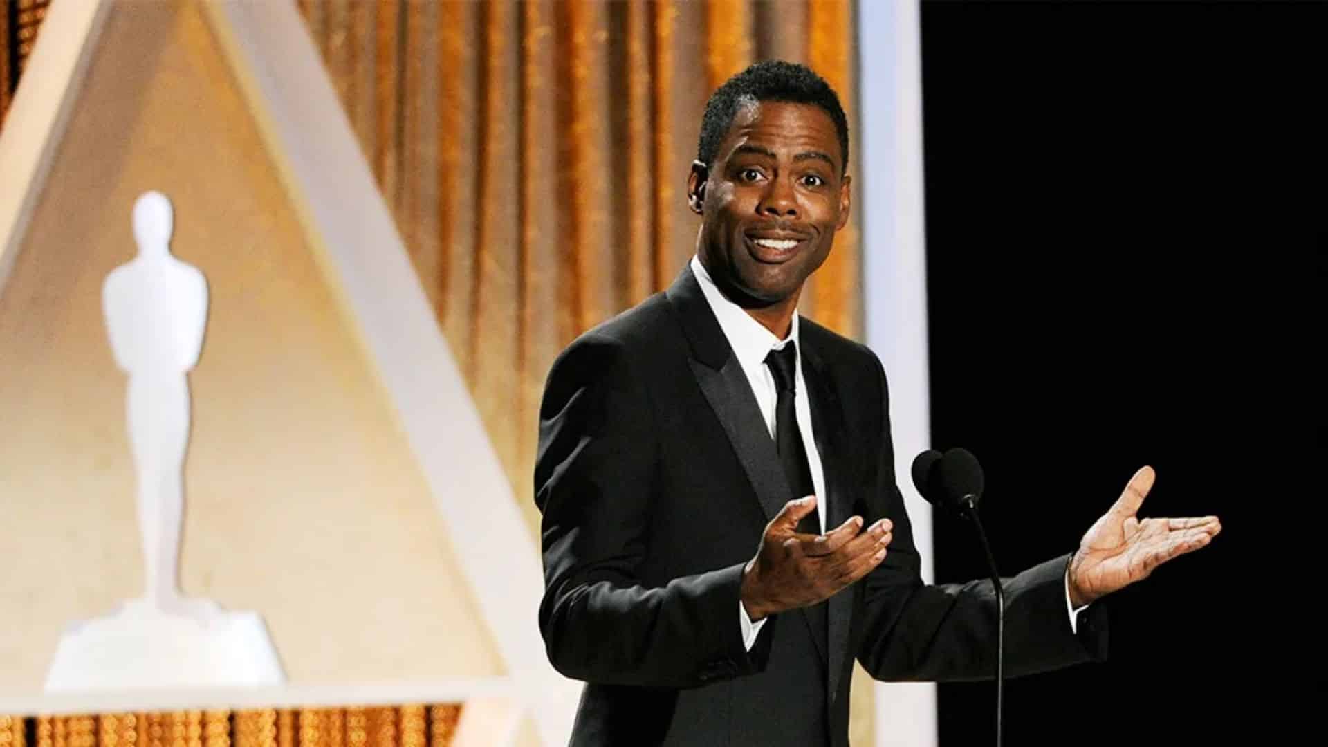 Chris Rock hosting the Oscars on stage during an awards ceremony